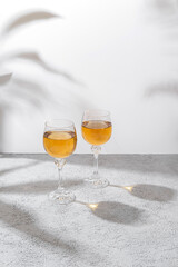 Two glasses of white wine on light background. Wine making and wine degustation concept. Free space for your text