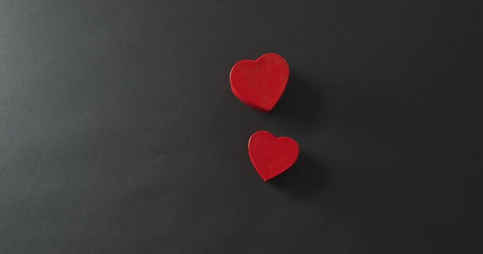 Red hearts shape boxes at valentine's day on gray background