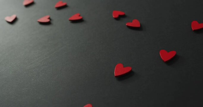 Red wooden hearts on gray background at valentine's day
