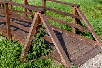 Fototapeta premium details of an old wooden bridge over a small river