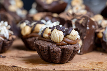 multicomponent cake made of caramel and nuts in chocolate