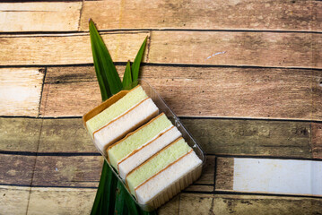 Pandan cake on the wooden floor sweet, soft, delicious food background with high resolution