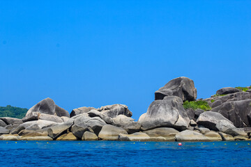 Fototapeta premium Granite rocks on the 9th island of Similan islands, Phuket, Thailand, blue sky, copy space for text, wallpaper