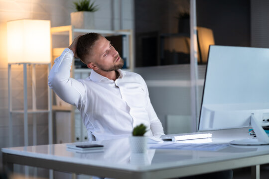 Man Stretching At Office Desk