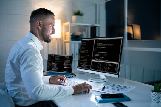 Computer Programmer Writing Program Code On Computer