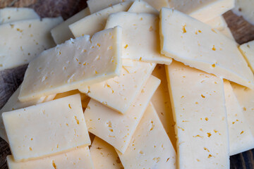 cut into pieces real hard cheese with lots of milk