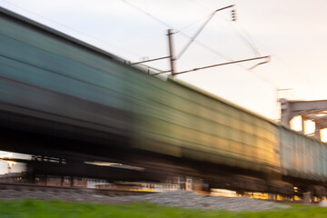 A blur of old train cars in motion. Speed and defocus.