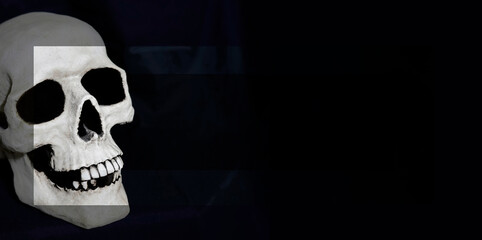 A skull made from resin on a dark background. The photo has been edited. Three layers of the same photo are put over each other