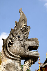 Lion statue in Wat Phra Sing Waramahavihan temple isolated blue sky.