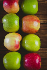 Red and green apples on table