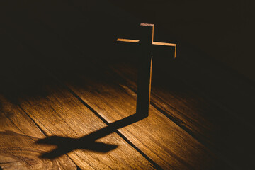 Wooden cross on hardwood floor