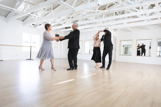 Caucasian senior couples ballroom dancing
