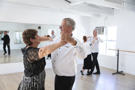 Happy Caucasian senior couples ballroom dancing