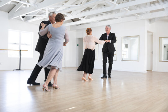 Caucasian senior couples ballroom dancing