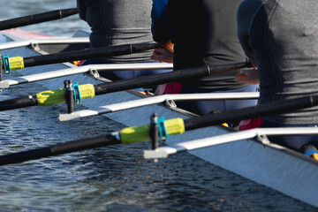 Mid section of senior caucasian rowing team rowing the boat on the lake