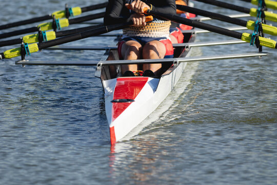Mid section of senior caucasian rowing team rowing the boat on the lake