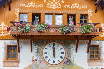 this house wall is a clock
cuckoo clock from the Black Forest - obrazy, fototapety, plakaty