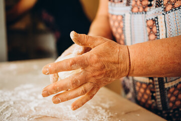 Making dough by male hands at bakery. Food concept.