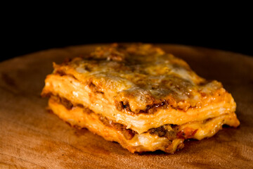 Lasagna or lasagne Bolognese on a wooden dish