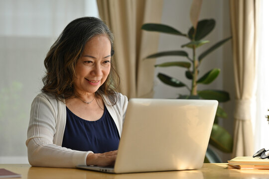 60s Middle Aged Businesswoman Working With Laptop Computer At Home, Online Working, Remote Working From Home.