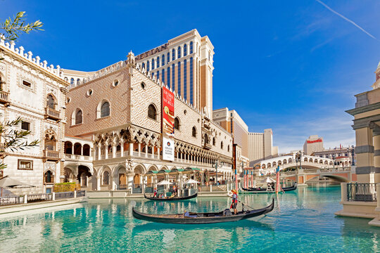 gondola with tourists at The Venetian Resort Hotel and Casino. The resort opened  1999 with flutter of white doves, sounding trumpets, singing gondoliers and actress Sophia Loren.