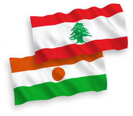 National vector fabric wave flags of Republic of the Niger and Lebanon isolated on white background. 1 to 2 proportion.