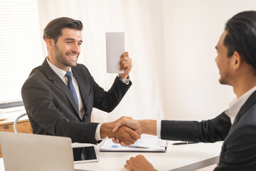 Handshake, caucasian male giving financial reward in an envelope, business letter extra salary to...