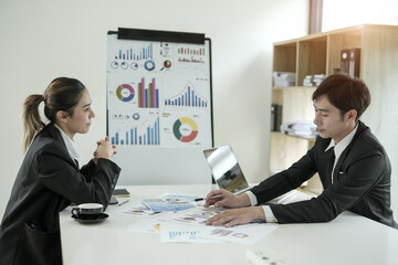 Asian businesswoman planning work in conference room with team