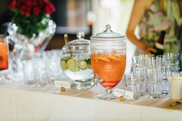 Jars with Alcoholic beverages at a wedding. Glasses and drinks at an event.