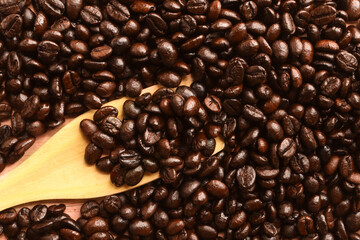 Coffee bean and wood spoon on wooden background