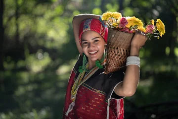 Fotobehang Beautiful Asian young tribal lady in the native traditional dress culture of Karen people minority ethnic culture. Portraits of identity dress folk applying fashion concepts. © pomphotothailand