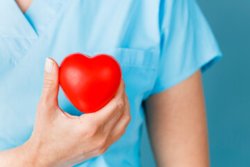 Medicine doctor holding red heart shape in hand, medical concept.