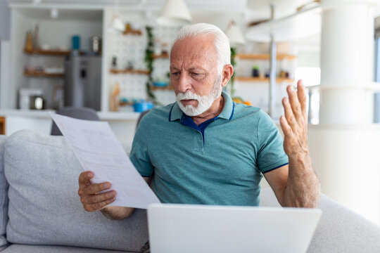 man worried about his monthly payments. Serious senior man holding letter feels interested read business news, got invitation, learns bank statement information. Postal correspondence concept