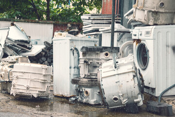 Broken White Washing Machines whole and detail parts on the street under rain fall