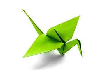 Fototapeta premium Green paper crane origami isolated on a white background