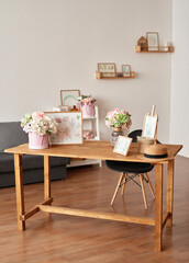 Pink living room and kitchen. Studio apartment. Loft interior. Shelves and spring decor in room. Rent and delivery of housing. Hostel and hotel