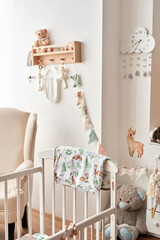 Scandinavian style white interior children's room, bedroom, nursery. Baby cot with canopy. Wooden shelves and toys.