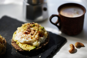 homemade delicious toast, topped with egg, tuna, cucumber and avocado