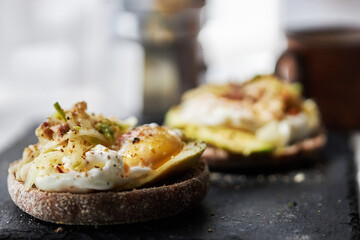 homemade delicious toast, topped with egg, tuna, cucumber and avocado