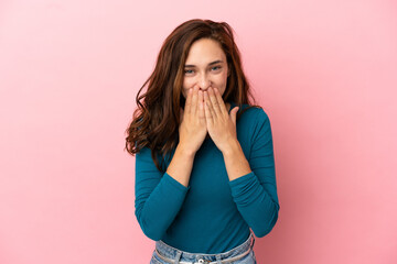 Young caucasian woman isolated on pink background happy and smiling covering mouth with hands