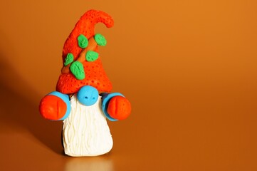 A figure of a dwarf on a bright background. Christmas toys and decorations.