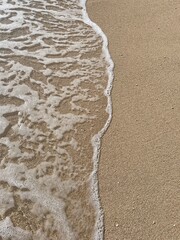 Soft sea wave on the beach, sand background

