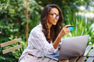 Young woman use credit card for online shopping on internet website. Online shopping, e-commerce, internet banking, spending money. Black Friday.