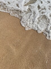 Soft sea wave on the beach, sand background
