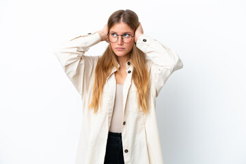 Young blonde woman isolated on white background frustrated and covering ears