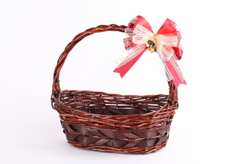 Bamboo basket isolated on white background Decorated with red ribbons and golden on top.