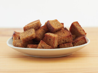 Salted croutons in a bowl on a light background