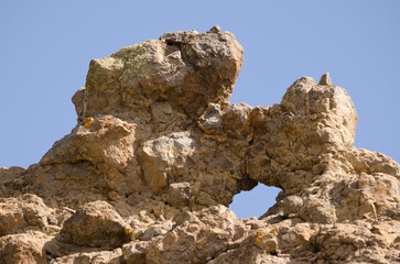 Rocky cliff with a hole. San Bartolome de Tirajana. Gran Canaria. Canary Islands. Spain.