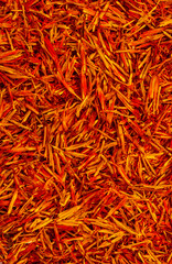 Saffron spice, pistils and stigmas of a crocus flower close-up, flat lay as a background. Indian...