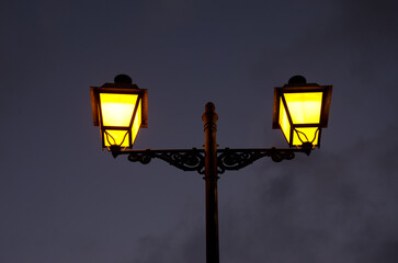 Street lamps lit at dusk. Santa Lucia de Tirajana. Gran Canaria. Canary Islands. Spain.